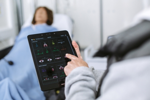 Doctor checking patient's vital signs on iPad