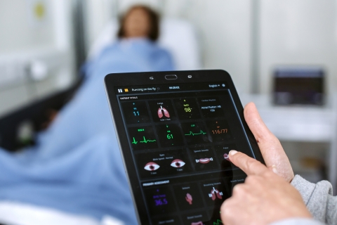 doctor studying vitals on tablet computer