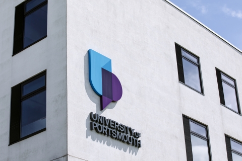 corner of University of Portsmouth building with logo