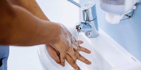 Nursing student washing hands.