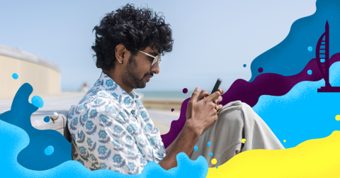 Man using his phone on the beach 