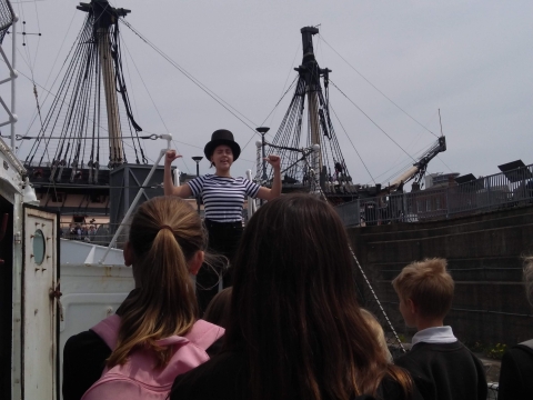 Students performing play on warship