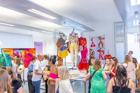 people in the fashion studio attending the 2025 graduate showcase