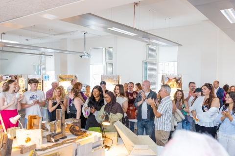 group of people attending graduate show 2025