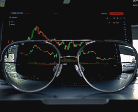 A pair of glasses in front of a financial analysis
