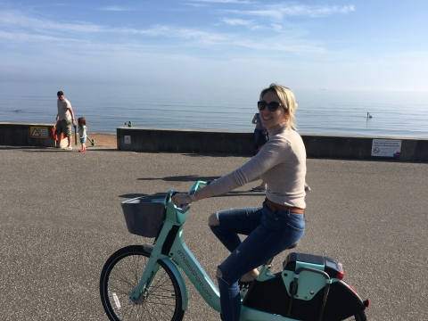 Evgenia Georgieva cycling on a bike, enjoying the outdoors.