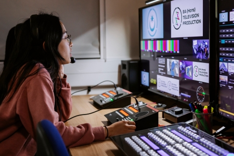 Student in CCI TV Studio Gallery during a live broadcast.