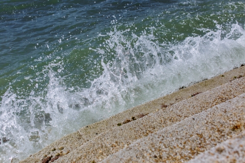 Waves crashing onto sea defence steps