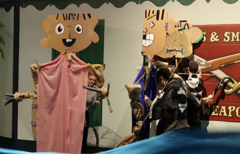 school children interact with large cardboard characters
