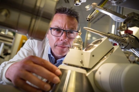 Image of Professor John McGeehan working on a microscope