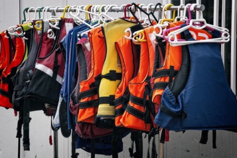 A rack of lifejackets in multiple colours