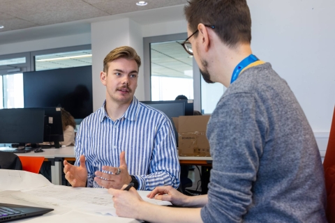 Two people discussing an assignment