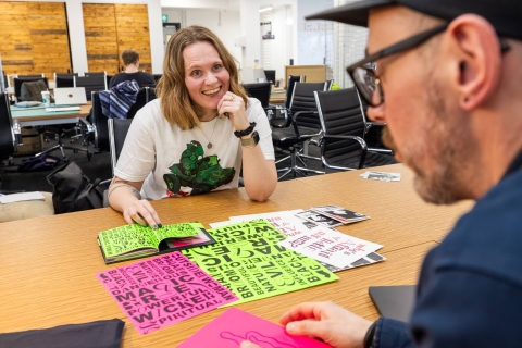 Two people discussing an assignment