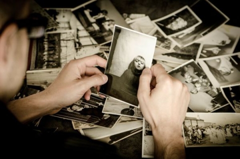 Man looking through old black and white photos