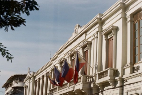 Large building with three Philippine flags in front