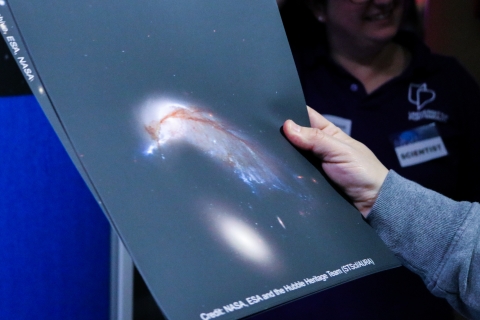 Someone holding a picture showing a solar system