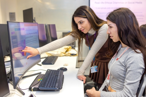 two students working on a project on a computer