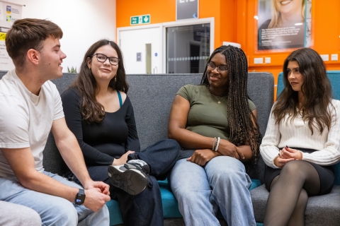 Four students talking together