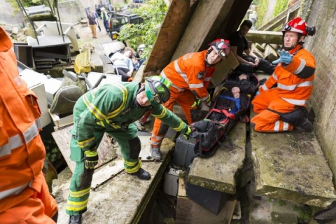 Emergency rescue crews treating a patient in collapsed building.