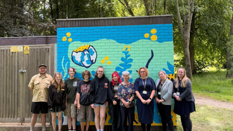 Group of people in front of mural