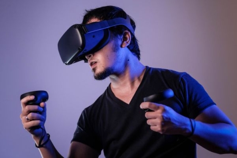 Man wearing Virtual Reality goggles and gaming