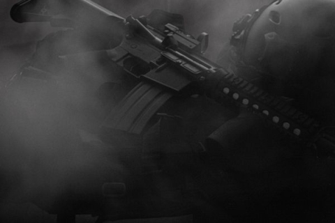 A large gun engulfed in dark smoke