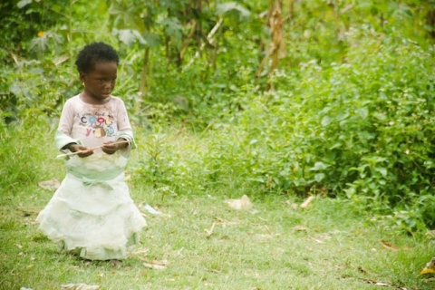 child playing outside in a rural area