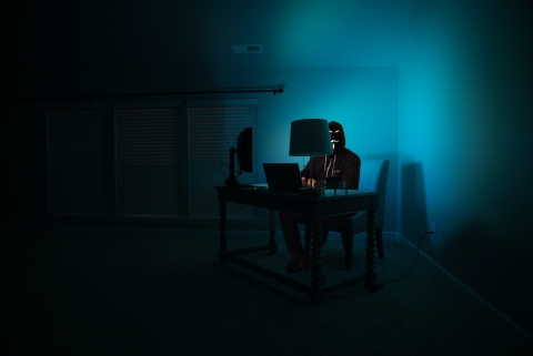 Hacker with mask information of computer - Photo by Clint Patterson on Unsplash