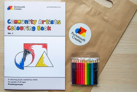 Portsmouth Create's community artist colouring book next to coloured pencils