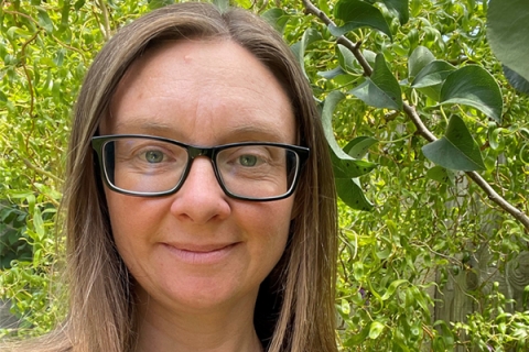 Emma Kemp with green bushes in the background