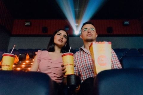 Man and woman sat next to each other in cinema