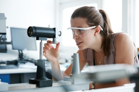 A researcher looking through lenses