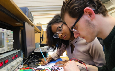 Two students working on an electronic engineering project