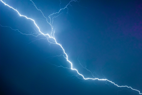 A lightning strike on a dark blue sky