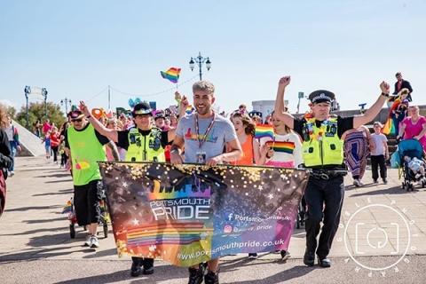 Police and civilians supporting and parading for pride month
