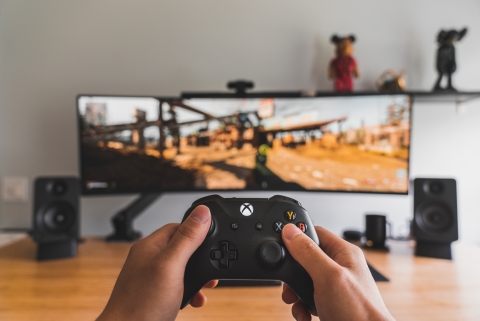Gaming console in front of video game - Photo by Sam Pak on Unsplash