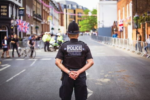A police officer standing on a UK street