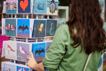 Woman shopping for postcards outside entrance of Hotwalls Studios
Hot Walls - City Guide 2022