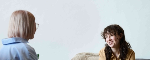 Two women talking in a therapy setting