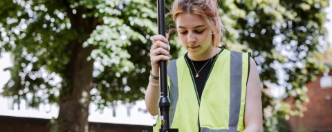 Student uses measurement device outside of Technology Facilities