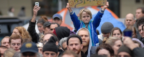 Young child holding sign at a climate change protest