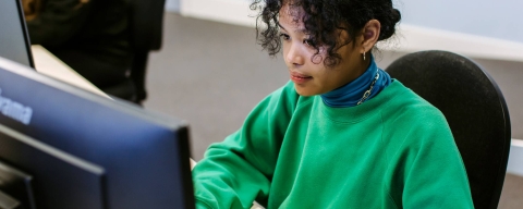 Woman typing on a computer
