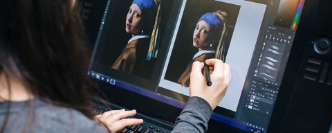 Computer animation student uses stylus on screen