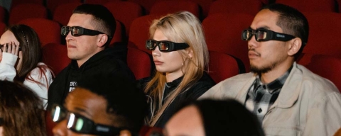 People watching a film in a cinema all wearing 3D glasses