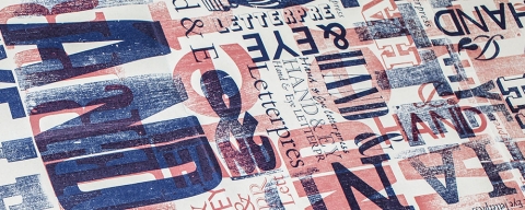 Printed letterpress sample text in blue and red ink
