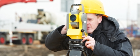 Student using surveying equipment