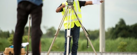 Civil engineers using surveying equipment