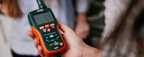 Close up of hand holding moisture meter