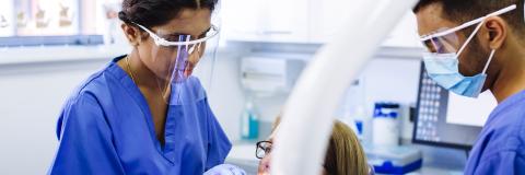 Dental nurses treating patient