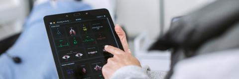 Doctor checking patient's vital signs on iPad